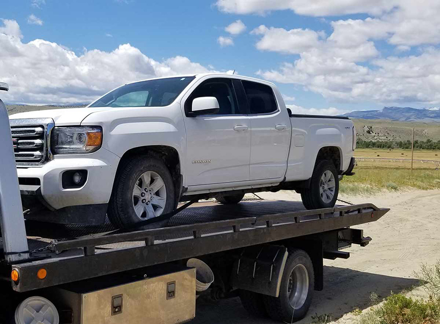 truck-towing-lander-wyoming Flatbed tow truck towing a white truck
